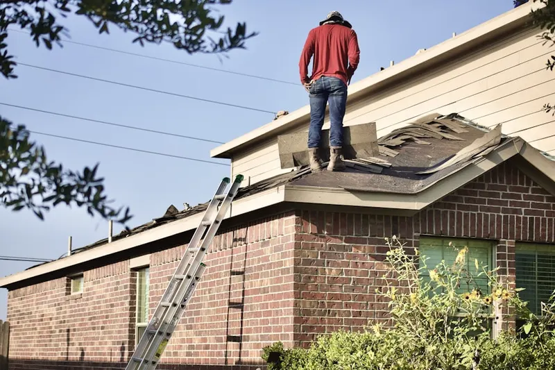 Professional roofer working on a residential roof in Rawhide